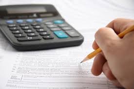 Preparing tax paperwork with a calculator